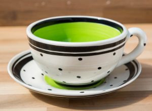 Black and white cup and saucer in polka dot